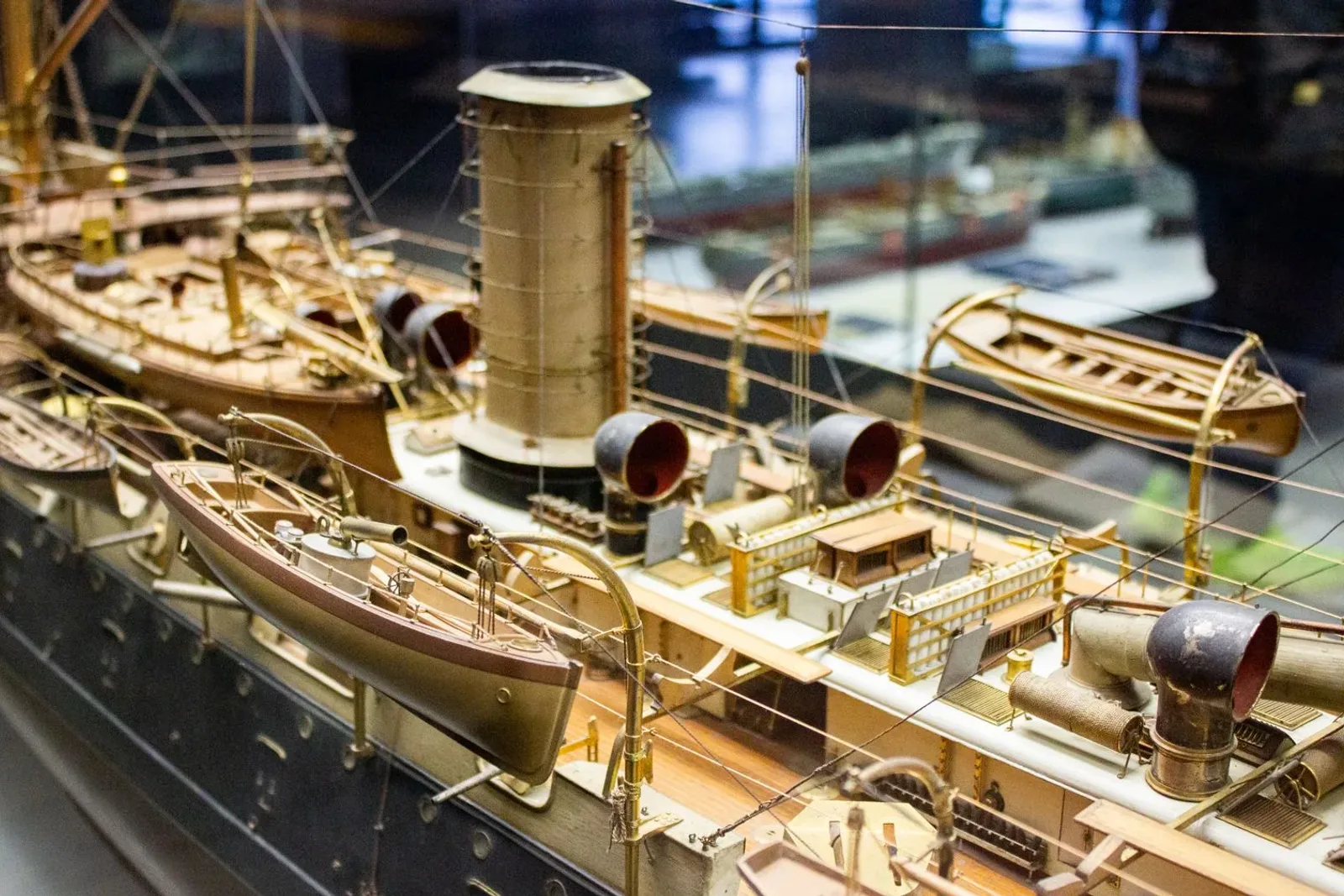 Detailed model ship displayed beneath museum lighting