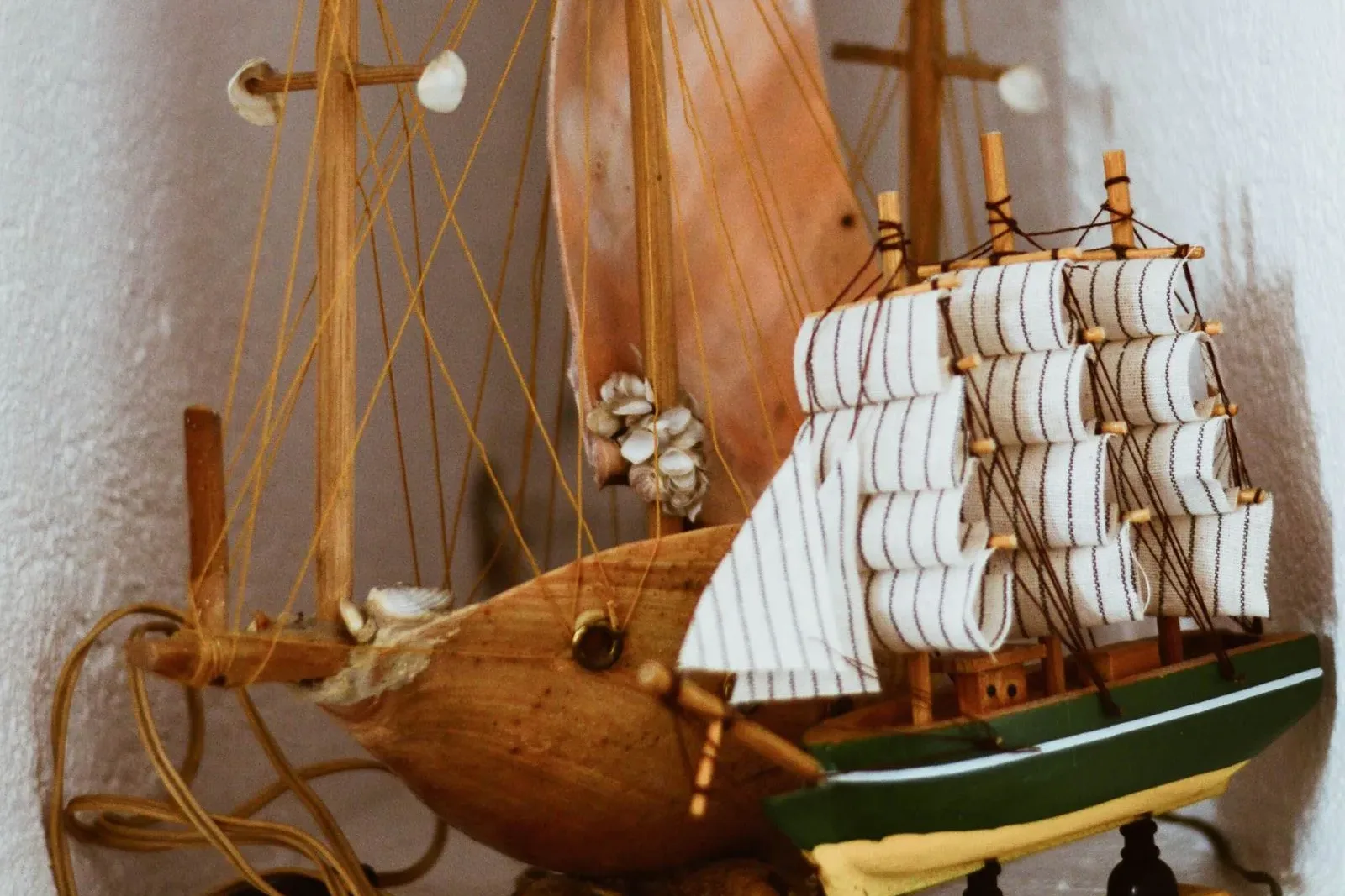 A collection of intricate wooden ship models displayed indoors