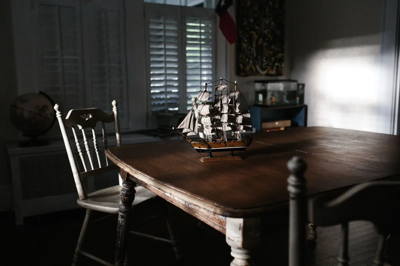 Wooden model ship on a table in a quiet historic room